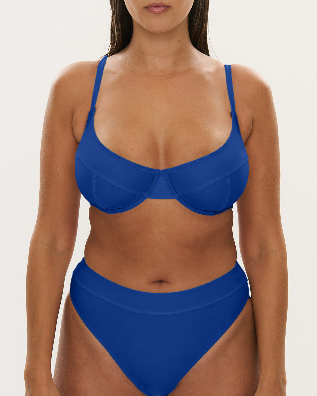 Woman wearing a blue bikini set on a white background